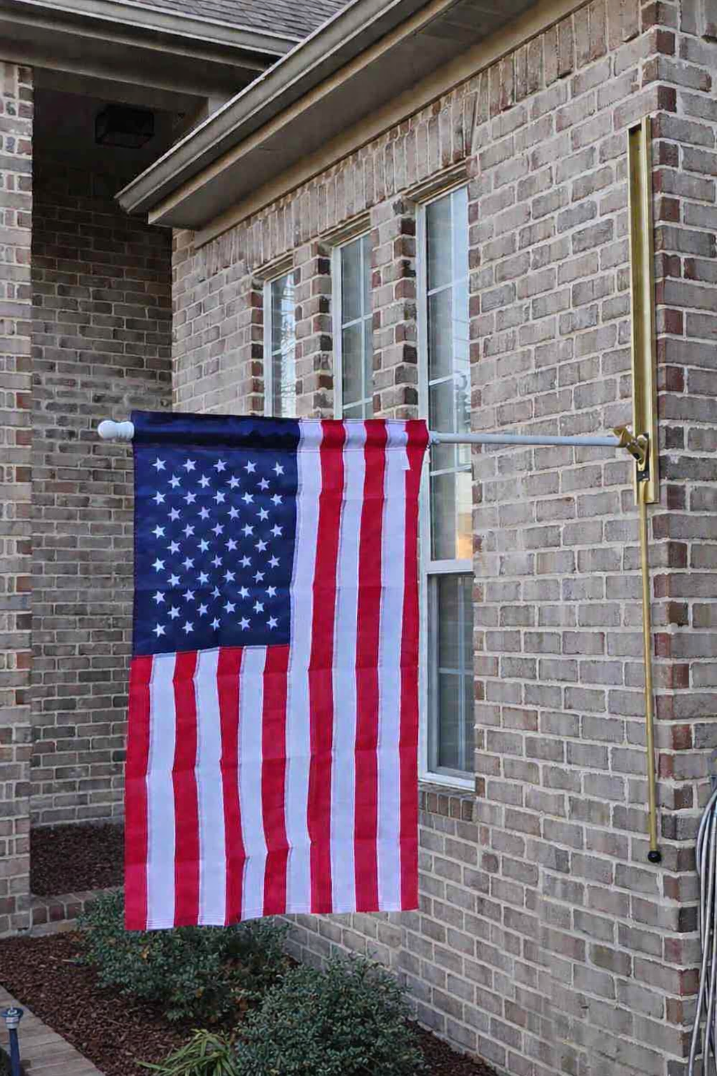 Gold VersaMast System with American flag in lowered position